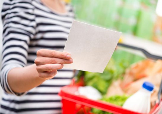 Woman in supermarket with list from Symply